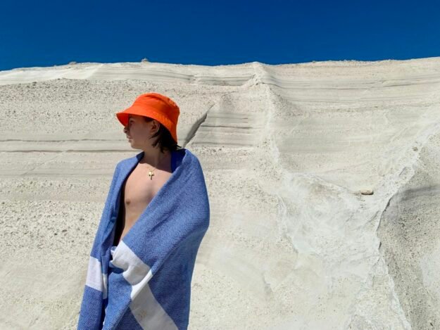 Woman wrapped in a towel on a beach — representative lifestyle photograph
