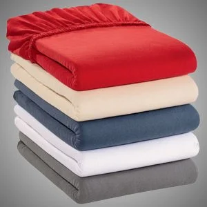 Stacked jersey fitted sheets in red, cream, blue, white and grey
